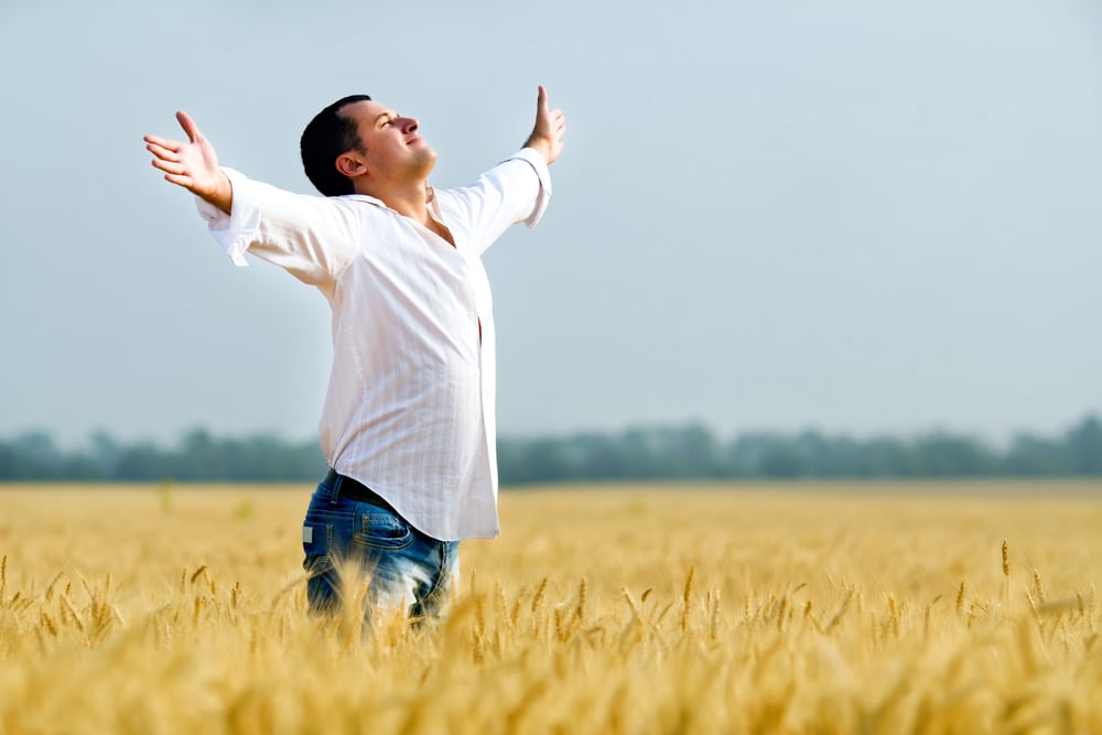 man excited with arms stretched out about hormone replacement therapy for men