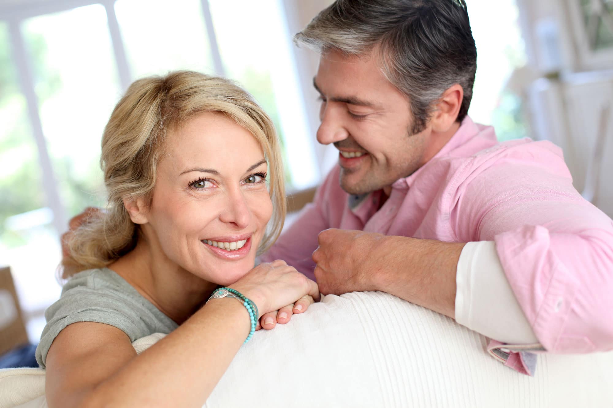 man and woman smiling considering the possibilities with bioidentical hormone replacement therapy