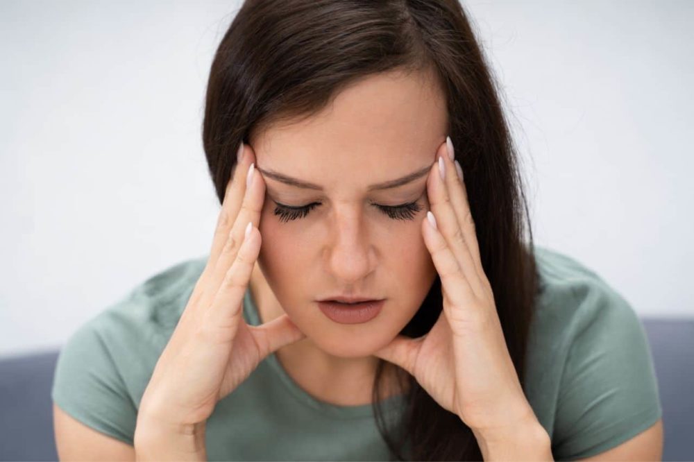 woman distraught and experiencing symptoms of hormone Imbalance in women