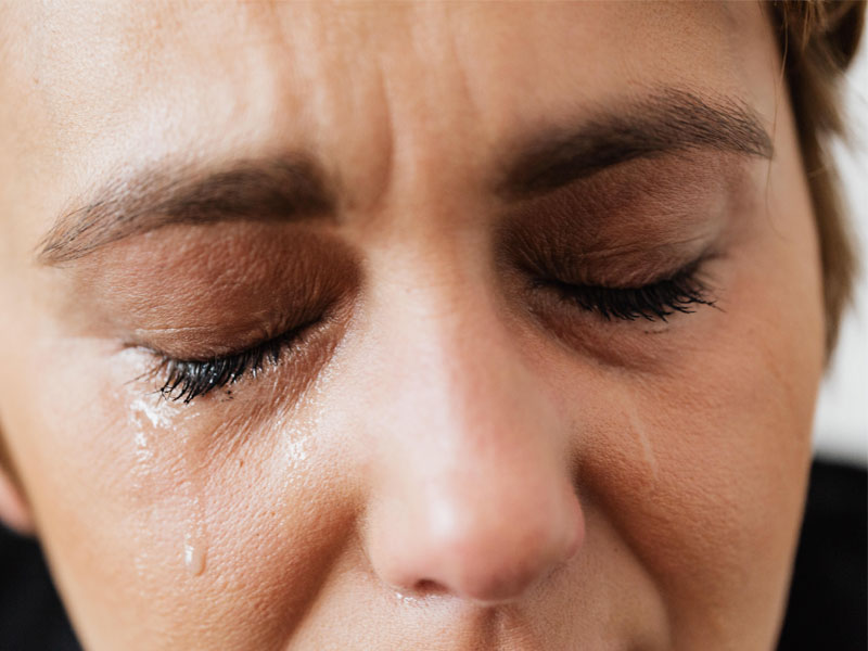 Close up of a woman's face with a tear to illustrate benefits of BHRT and adrenal fatigue treatment