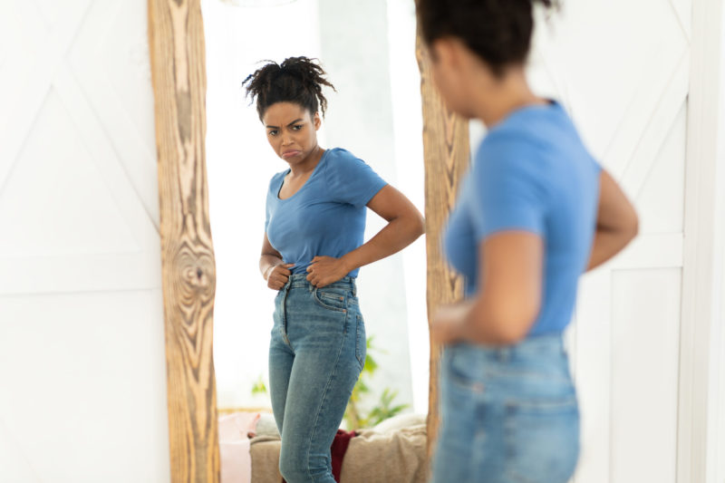 menopause weight gain - woman experience estrogen weight gain