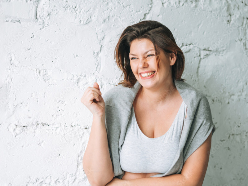 Laughing woman to illustrate having successfully finished a personalized weight loss program