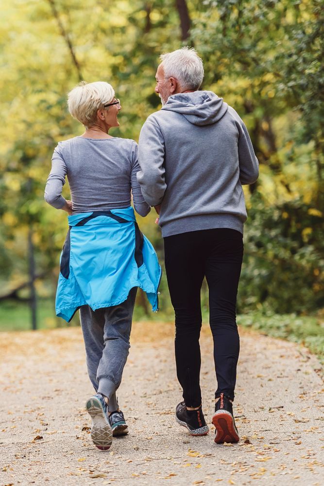 Happy couple takes a high energy walk together in a park