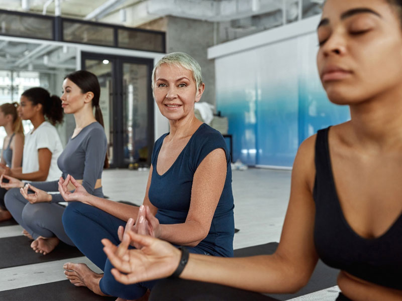 Ladies doing meditation and not worrying about female urinary incontinence after using Emsella