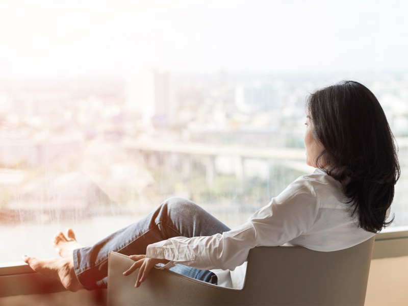 woman gazing into the distance to illustrate signs perimenopause is ending