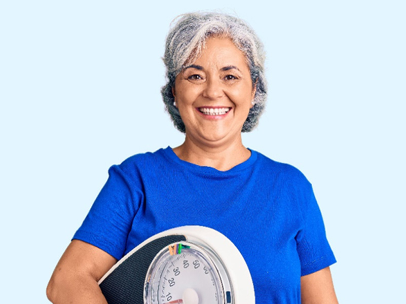 senior woman holding weight machine to illustrate NavaRX weight loss program