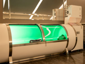 man lying in an oxygen chamber to illustrate hyperbaric oxygen therapy