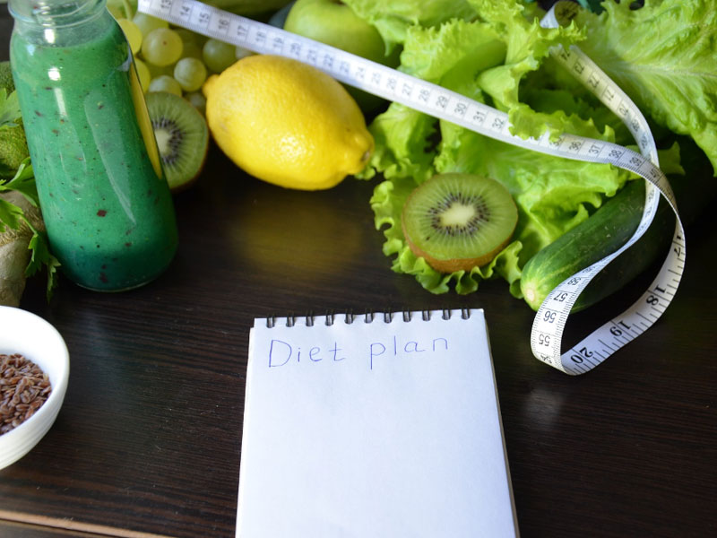 weigh loss plan notebook with deit foods and tape measure