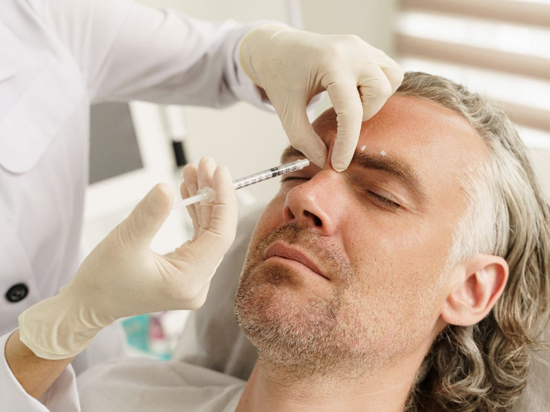 doctor injecting a dermal filler in a patient's face