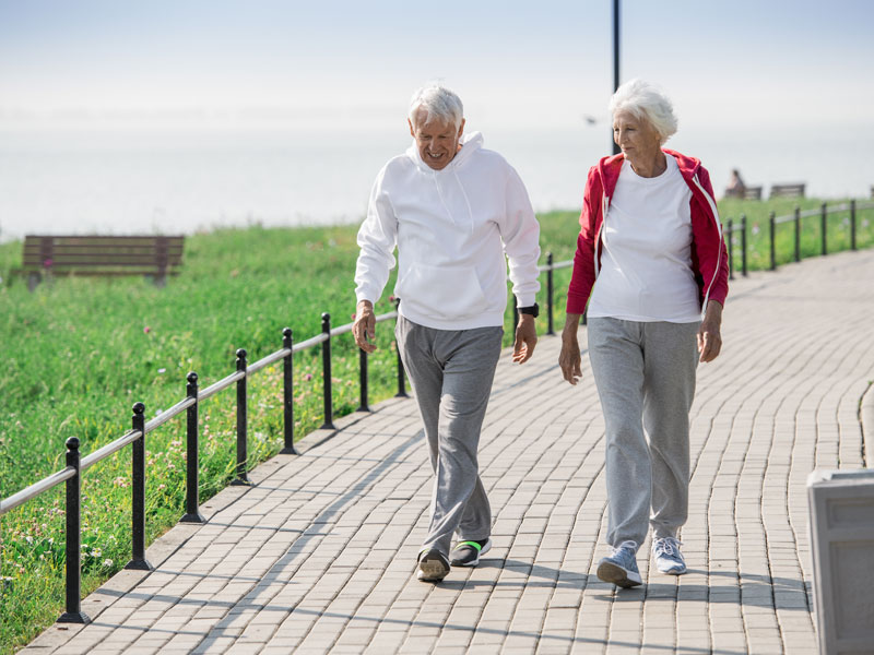 couple out walking and enjoying healthy longevity