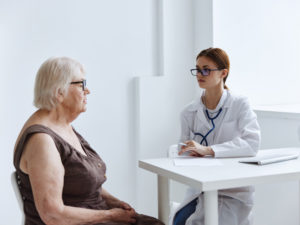 older woman patient consulting a doctor about healthy aging