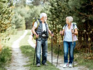 senior couple enjoying longevity hiking in the forest