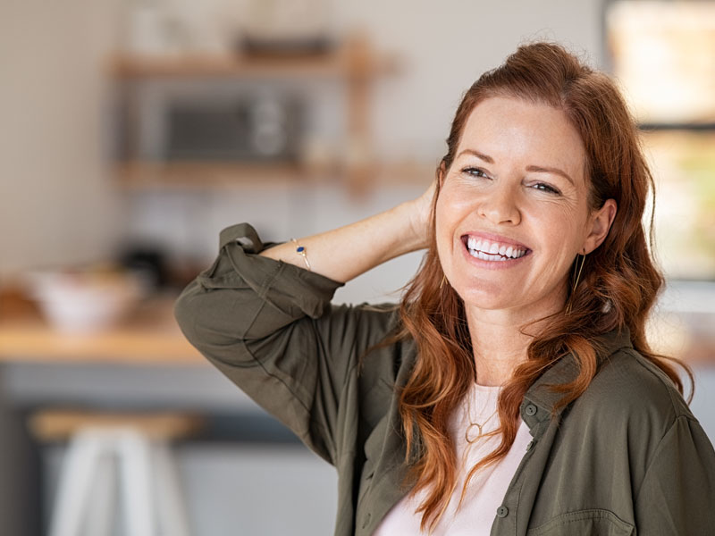 mature woman laughing to illustrate managing menopause fatigue