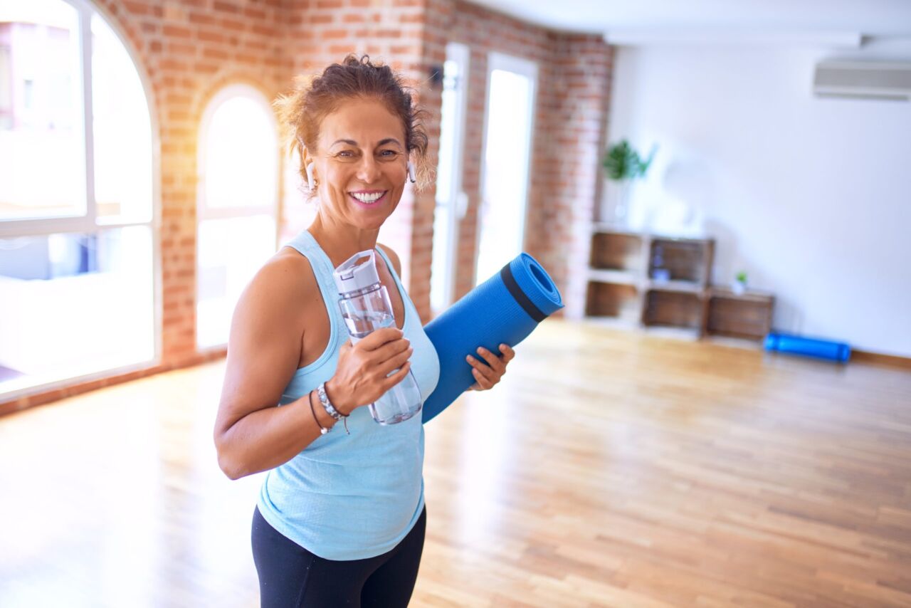 Middle age beautiful sportwoman smiling happy and confident to illustrate estradiol link with exercise.