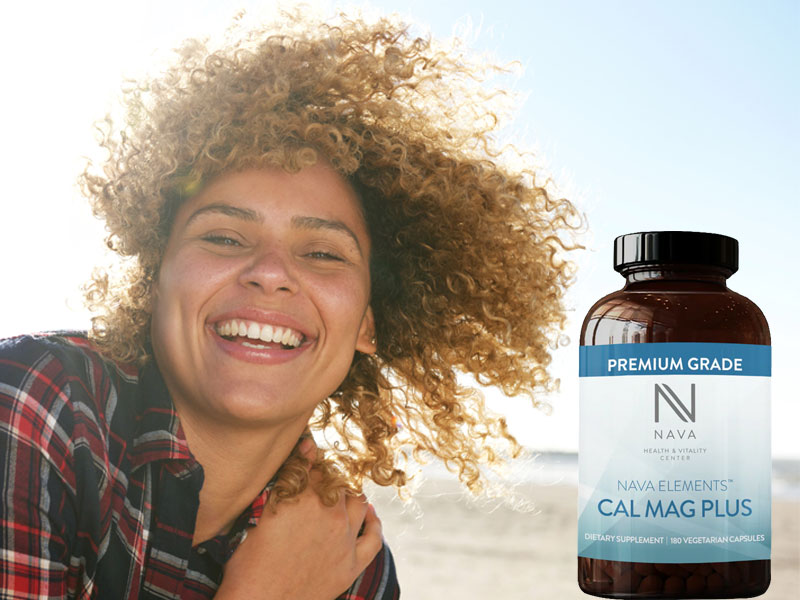 Happy woman with bottle of Nava CAL MAG PLUS to illustrate calcium and magnesium supplements