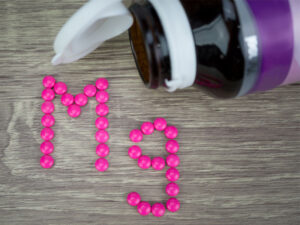magnesium tablets arranged to show the chemical sign Mg to illustrate magnesium supplementation