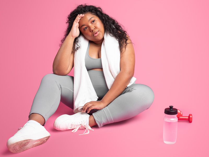 tired obese woman in sportswear to illustrate possible hormone replacement therapy for weight loss