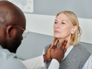 woman having her thyroid checked to illustrate hypothyroidism