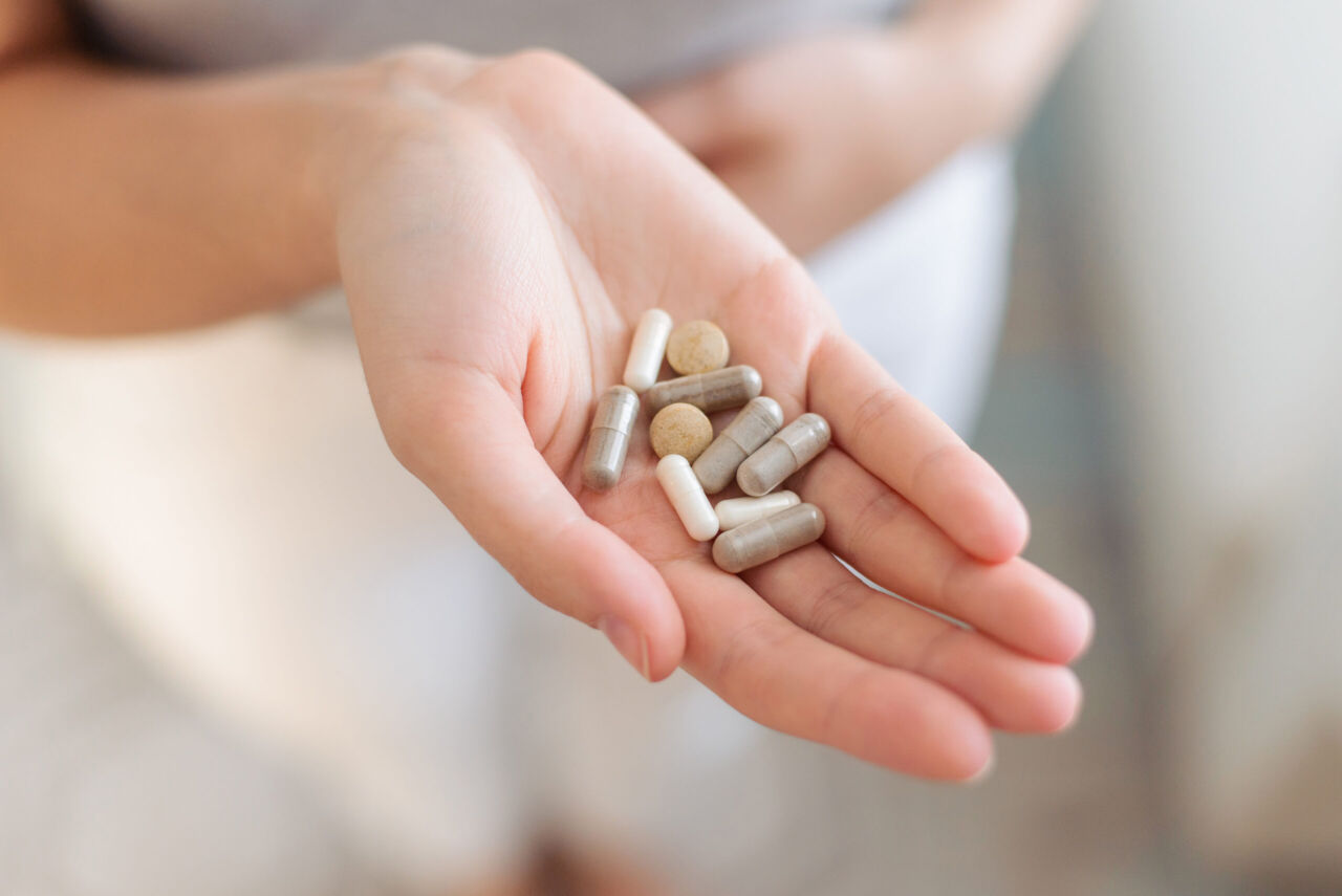 Tablets and biologically active supplements in the hand. Close up. Virus, cold, cough, cold, bacterial. Prevention and treatment.