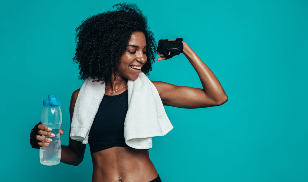 Fitness woman flexing muscles