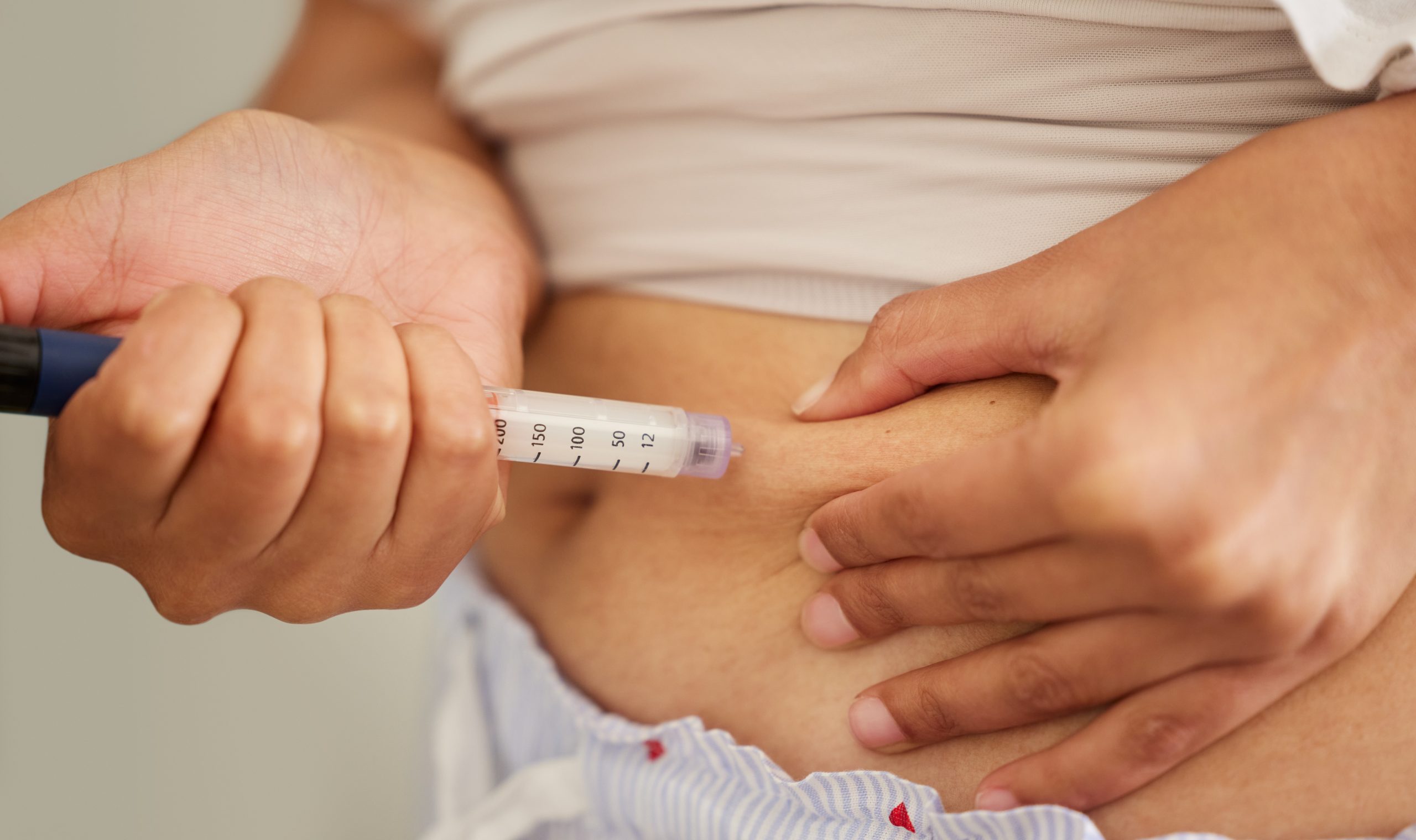 Licensed Woman, hands and insulin injecting in stomach for diabetes, medical condition and treatment at home. Needle pen, medication and syringe for health, wellness and care with medicine for weight loss