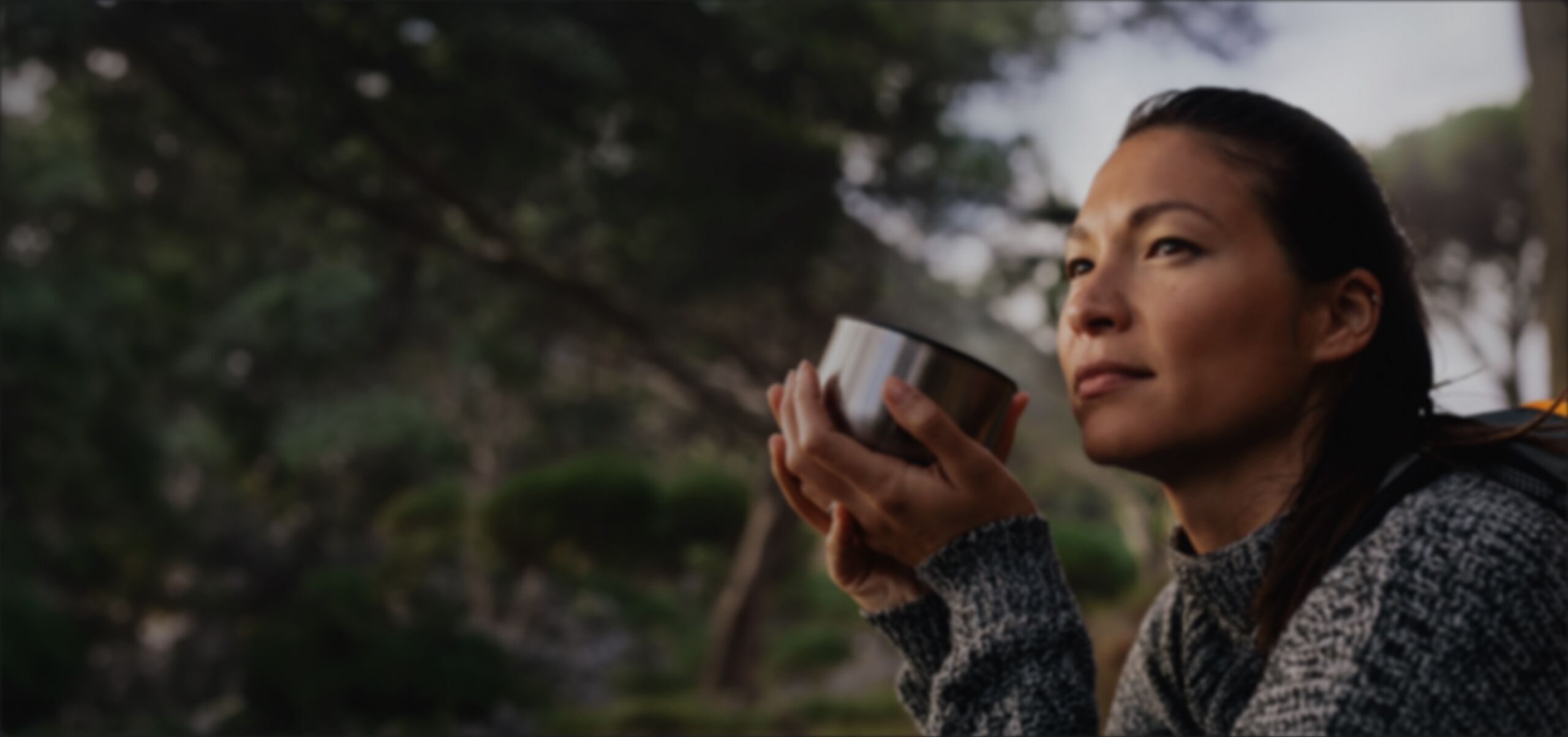 Woman drinking tea outdoors