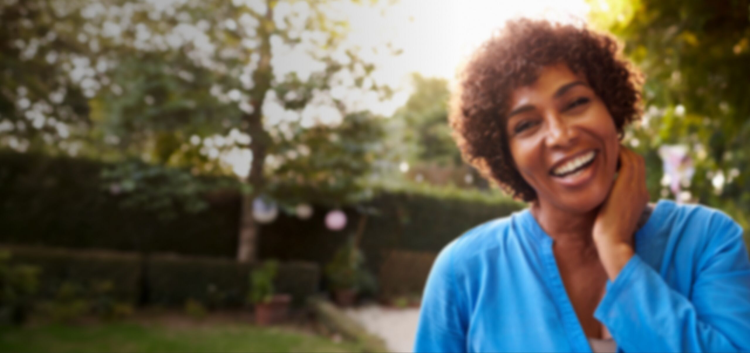 Woman smiling in a garden